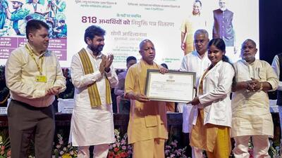 Chief minister Yogi Adityanath distributes appointment letters at a programme at Lok Bhavan in Lucknow on Saturday. (PTI PHOTO) Chief minister Yogi Adityanath distributes appointment letters at a programme at Lok Bhavan in Lucknow on Saturday. (PTI PHOTO)