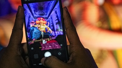 A person takes a picture of an idol of Lord Ganesh at a 'pandal' during 'Ganesh Chaturthi' celebrations, in Mumbai, Maharashtra. (PTI) A person takes a picture of an idol of Lord Ganesh at a 'pandal' during 'Ganesh Chaturthi' celebrations, in Mumbai, Maharashtra. (PTI)