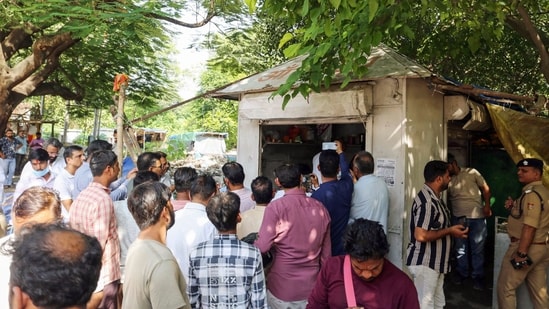 People gather as police inspect the site after Surendra Koli, accused in the Nithari case found dead in a tea stall, in Haridwar on Friday. (Rameshwar Gaur)