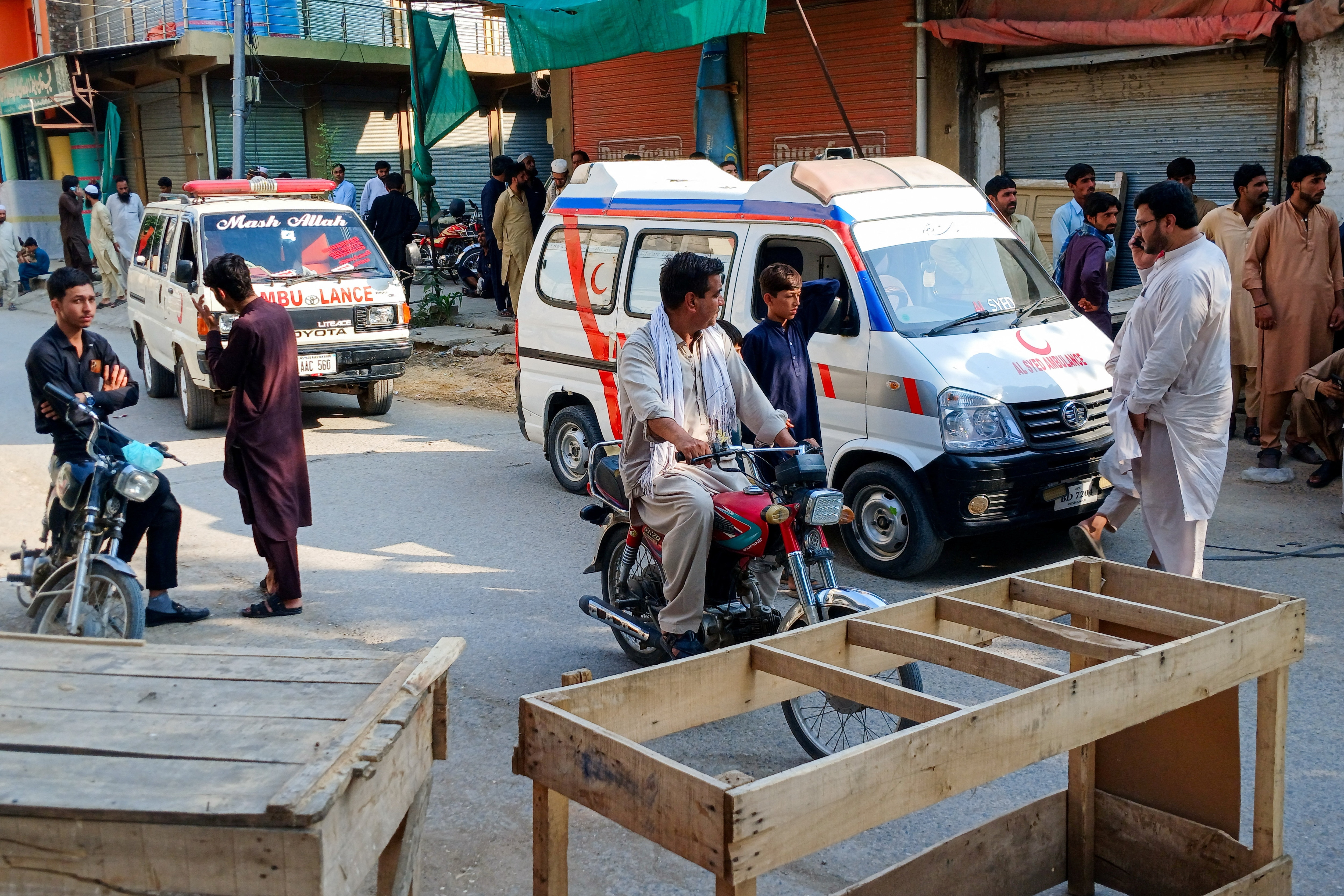 Ambulances and residents gather on a street leading to a police facility following a suicide attack in Kohat, Pakistan, September 18, 2026. REUTERS/Stringer (REUTERS)