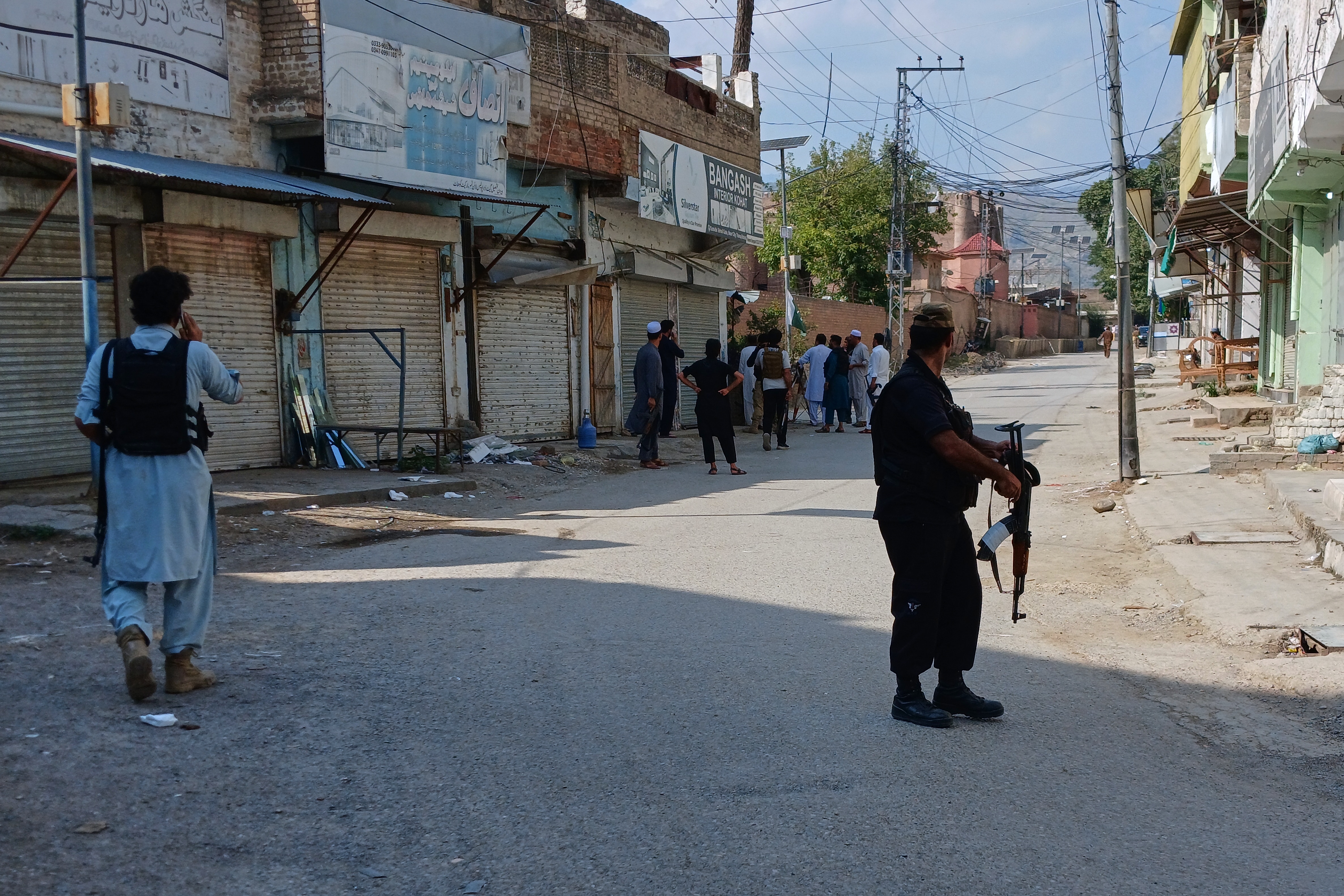 In this photo taken with a smartphone, police officers secure a road leading to the site of a powerful bomb at a mosque in Kohat, Pakistan, Friday, Sept. 18, 2026. (AP Photo/B.S. Gillani) (AP Photo/B.S. Gillani) In this photo taken with a smartphone, police officers secure a road leading to the site of a powerful bomb at a mosque in Kohat, Pakistan, Friday, Sept. 18, 2026. (AP Photo/B.S. Gillani) (AP Photo/B.S. Gillani)
