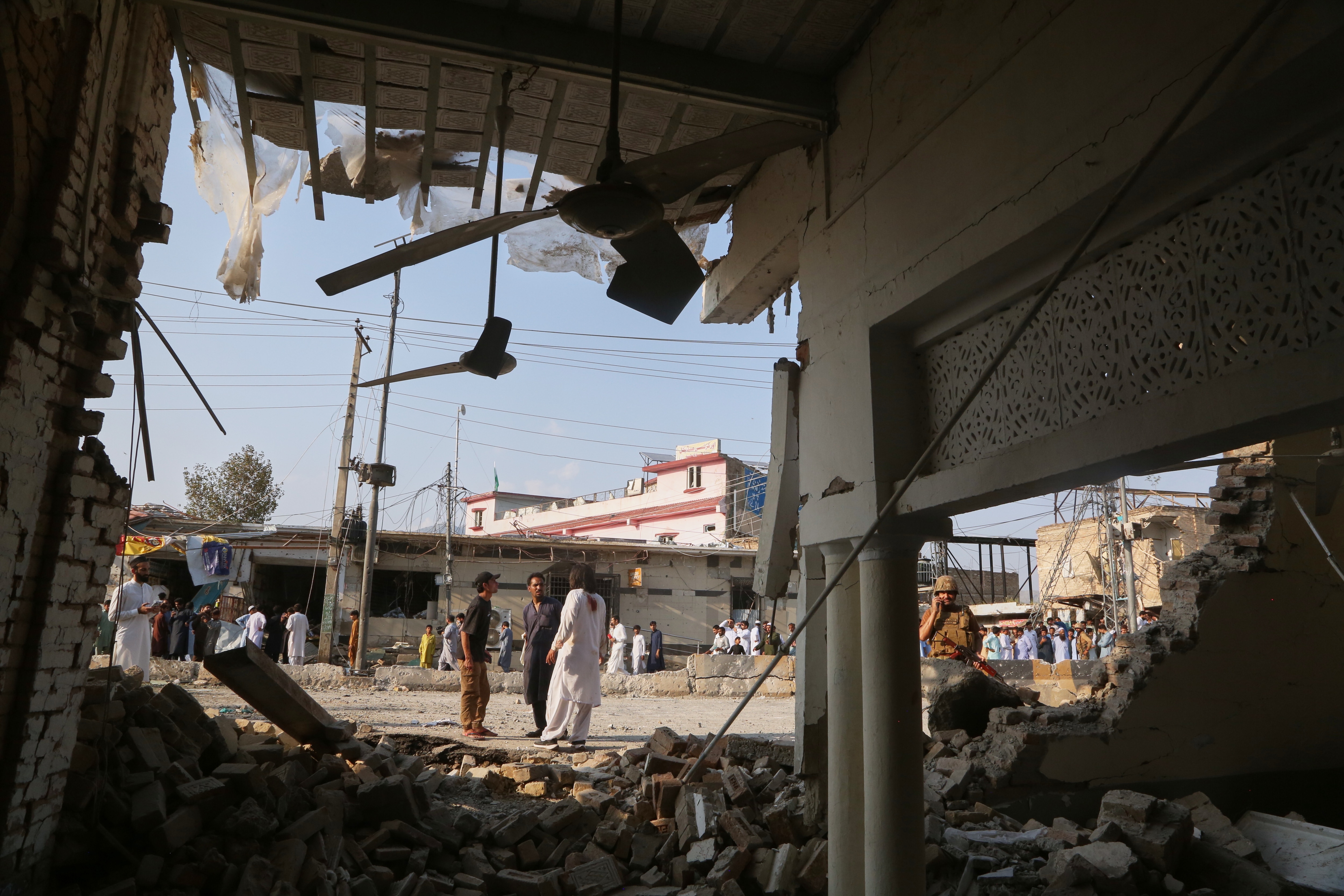 An Army soldier and local residents look at a damaged portion of a mosque after a bomb exploded in Kohat, in northwestern Pakistan, Friday, Sept. 18, 2026. (AP Photo/Muhammad Sajjad) (AP Photo/Muhammad Sajjad) An Army soldier and local residents look at a damaged portion of a mosque after a bomb exploded in Kohat, in northwestern Pakistan, Friday, Sept. 18, 2026. (AP Photo/Muhammad Sajjad) (AP Photo/Muhammad Sajjad)