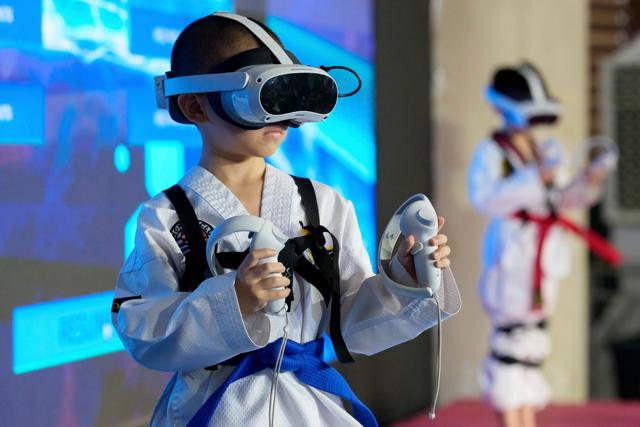 A young virtual taekwondo athlete competes during a taekwondo competition event in Kuala Lumpur. (AP)