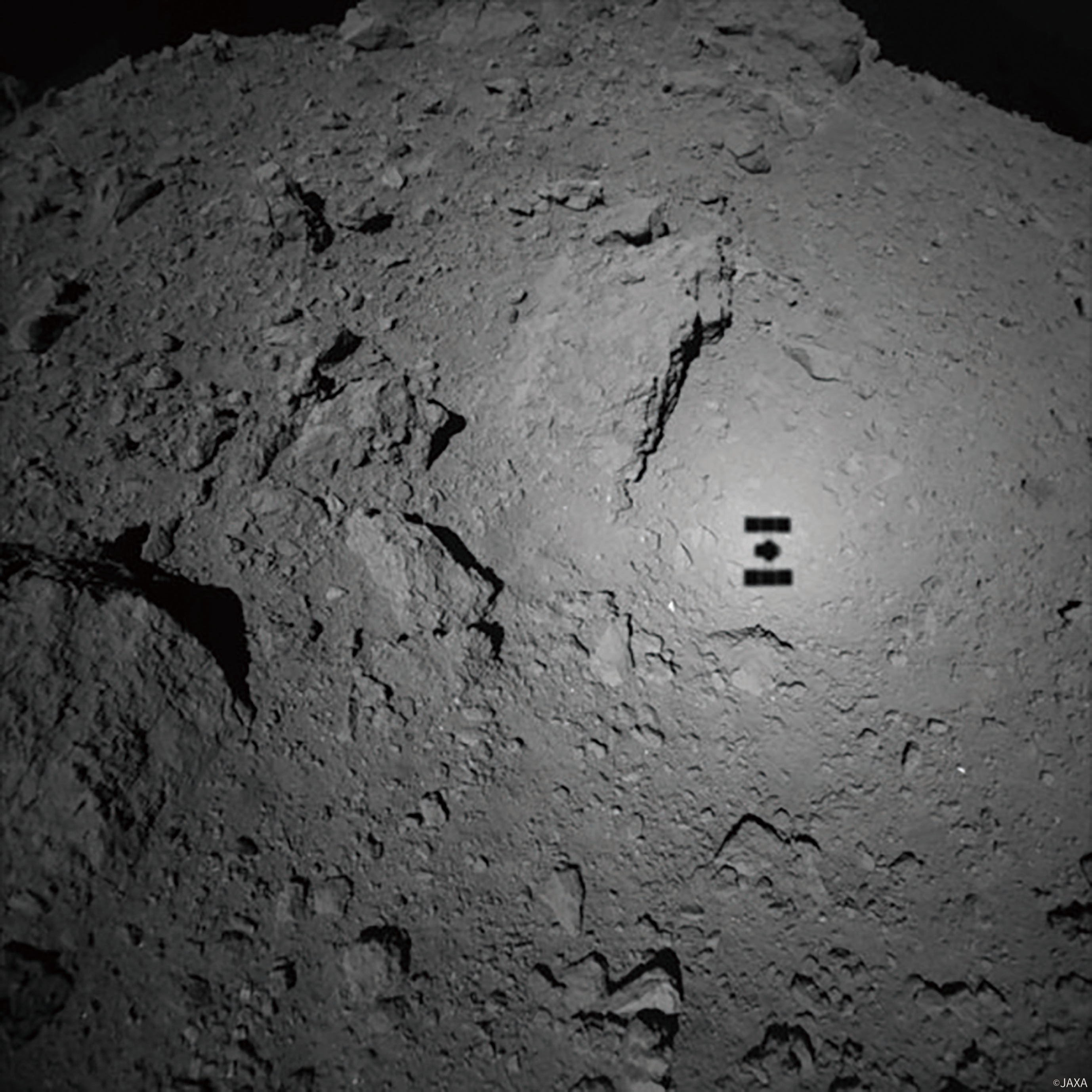 The shadow of Japan Aerospace Exploration Agency’s Hayabusa2 on the surface of Ryugu. In 2020, the research mission returned with 5 gm of surface material from the carbon-rich asteroid. (JAXA) The shadow of Japan Aerospace Exploration Agency’s Hayabusa2 on the surface of Ryugu. In 2020, the research mission returned with 5 gm of surface material from the carbon-rich asteroid. (JAXA)