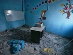 Colourful tree and flower decorations remain on the walls of a rubble-strewn classroom at Shajareh Tayyebeh school, damaged in a U.S. airstrike on February 28, in Minab, southern Iran.(AP Photo)
