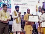 Chief minister Yogi Adityanath distributes appointment letters at a programme at Lok Bhavan in Lucknow on Saturday. (PTI PHOTO)