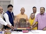 Chief minister Yogi Adityanath meets the chairman and officials of the Uttar Pradesh Go Seva Ayog (Cow Service Commission) on Saturday. (PTI PHOTO)
