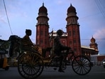 A commuter travels by cycle rickshaw in front of the Madras High Court early in the morning in Chennai on June 24, 2026. (AFP)