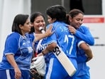 Shafali Verma is being congratulated by her team-mates.