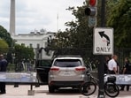 U.S. Secret Service Police stand near a car that sits parked on a sidewalk near the White House after the driver was arrested. (AP Photo/Jose Luis Magana)