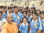 Uttar Pradesh chief minister Yogi Adityanath with students in Lucknow on Saturday. (SOURCED IMAGE)