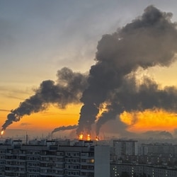 Plumes of smoke rise from fires (centre) at an oil refinery following what the authorities say is a Ukrainian drone strike in the course of the Russia-Ukraine conflict, in Moscow