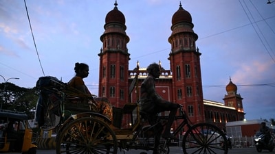 A commuter travels by cycle rickshaw in front of the Madras High Court early in the morning in Chennai on June 24, 2026. (AFP) A commuter travels by cycle rickshaw in front of the Madras High Court early in the morning in Chennai on June 24, 2026. (AFP)