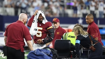Jayden Daniels #5 of the Washington Commanders looks on before being carted off the field after sustaining an injury against the Dallas Cowboys in the second quarter of a game at AT&T Stadium in Arlington, Texas. (Getty Images via AFP) Jayden Daniels #5 of the Washington Commanders looks on before being carted off the field after sustaining an injury against the Dallas Cowboys in the second quarter of a game at AT&T Stadium in Arlington, Texas. (Getty Images via AFP)