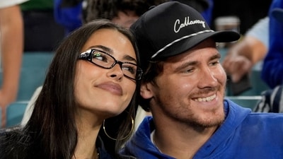FILE - Los Angeles Chargers quarterback Justin Herbert and girlfriend Madison Beer watch the Toronto Blue Jays and the Los Angeles Dodgers compete during the seventh inning in Game 3 of baseball's World Series, Monday, Oct. 27, 2025, in Los Angeles. (AP Photo/Ashley Landis, File)