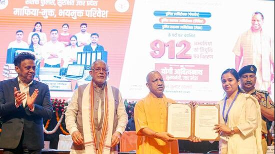 Chief minister Yogi Adityanath distributing appointment letters in Lucknow on Sunday. (ANI PHOTO)