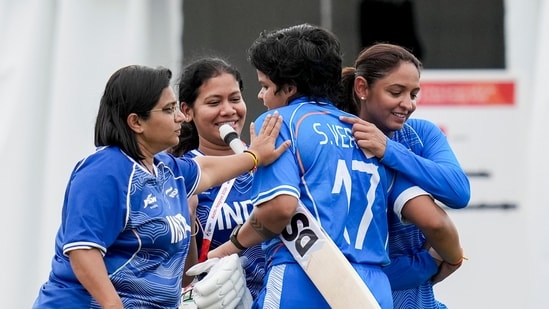 Shafali Verma is being congratulated by her team-mates.