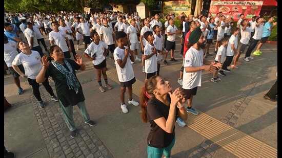 Participants during an event organised by the Indian Air Force on a pleasant morning at Sukhna Lake on Sunday. The day temperature was 35°C, 2°C above normal. (Keshav Singh/HT)