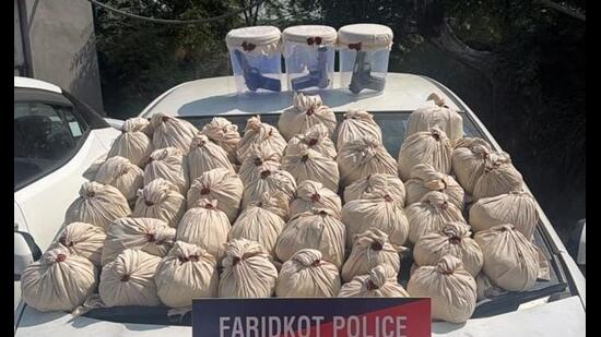 The Faridkot district police on Sunday busted a cross-border smuggling network with the arrest of four operatives, seizing 47.3 kg of heroin, three .30 bore pistols, three magazines, and 15 cartridges. (HT Photo)