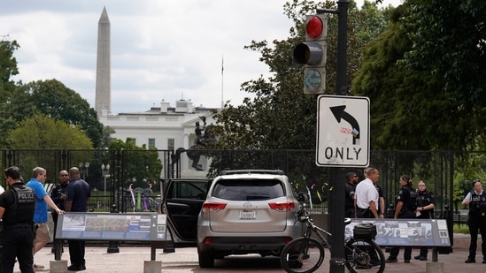 U.S. Secret Service Police stand near a car that sits parked on a sidewalk near the White House after the driver was arrested. (AP Photo/Jose Luis Magana) (AP Photo/Jose Luis Magana)