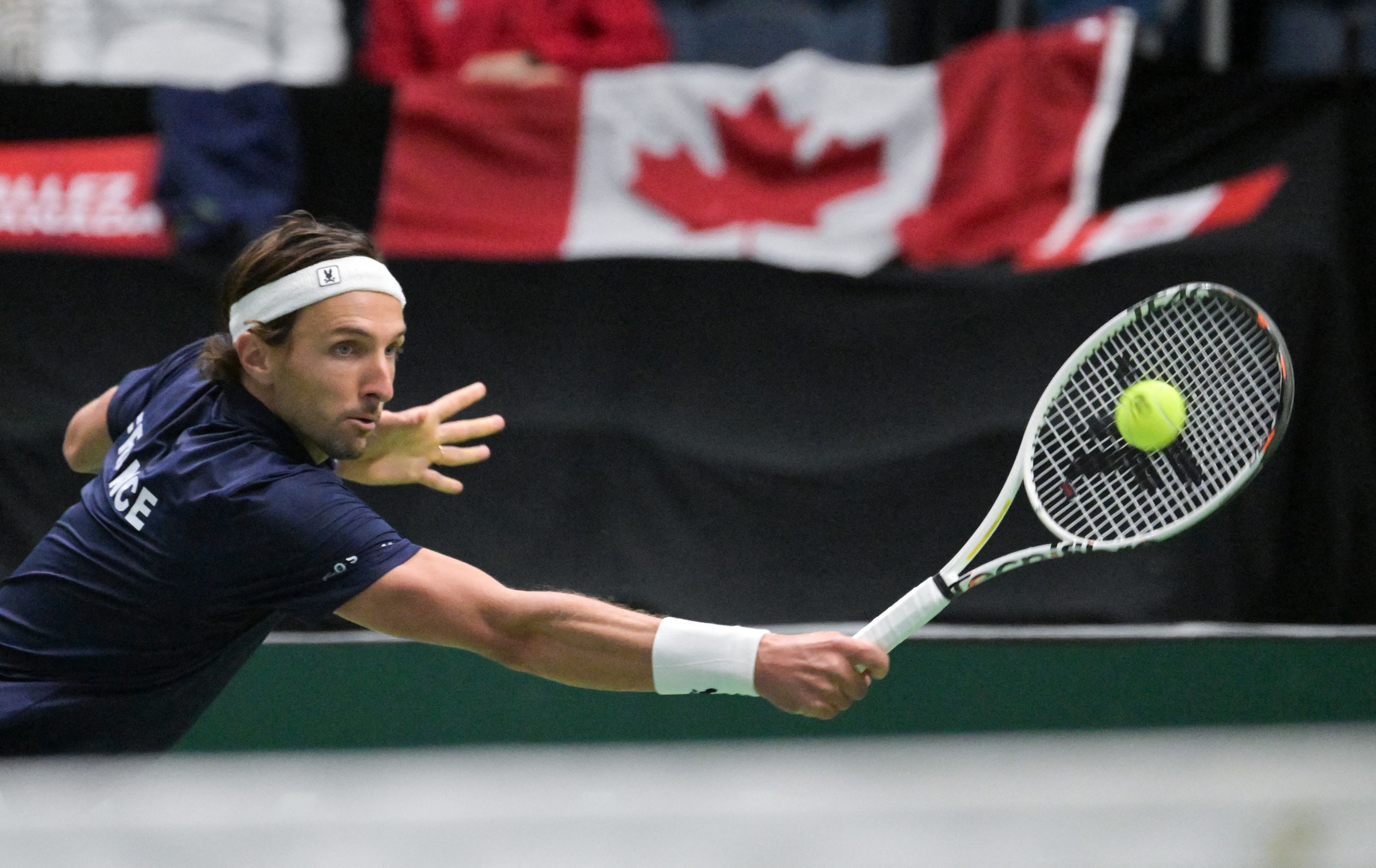 Arthur Rinderknech (FRA) hits a backhand against Felix Auger-Aliassime (CAN) during a Davis Cup second round qualifier match at Centre Videotron. (IMAGN IMAGES via Reuters Connect)