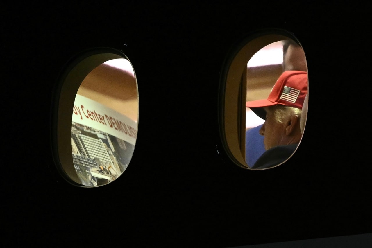 Through airplane windows, President Trump was seen with a printout related to the Kennedy Center. Through airplane windows, President Trump was seen with a printout related to the Kennedy Center.