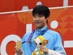 Asian Games - Aichi-Nagoya 2026 - Swimming - Tokyo Aquatics Centre, Koto, Tokyo, Japan - September 21, 2026 Gold medallist China's Zidi Yu celebrates on the podium after winning the Women's 200m Individual Medley Final REUTERS/Manami Yamada (REUTERS)