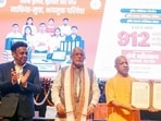Chief minister Yogi Adityanath distributing appointment letters in Lucknow on Sunday. (PTI PHOTO)