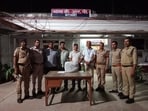 Policemen with the charas recovered from the general compartment of a train in Barabanki on Monday (HT Photo)