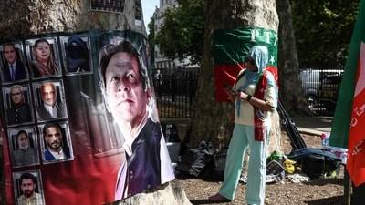 A woman looks at a banner showing Pakistan's jailed former prime minister Imran Khan (L) as a small group of people hold a rally opposite Downing Street in central London on August 23, 2026. A woman looks at a banner showing Pakistan's jailed former prime minister Imran Khan (L) as a small group of people hold a rally opposite Downing Street in central London on August 23, 2026.