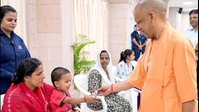 Chief minister Yogi Adityanath gives chocolate to a child during Janata Darshan, in Lucknow on Monday. (@CMOfficeUPX/ANI Photo) Chief minister Yogi Adityanath gives chocolate to a child during Janata Darshan, in Lucknow on Monday. (@CMOfficeUPX/ANI Photo)