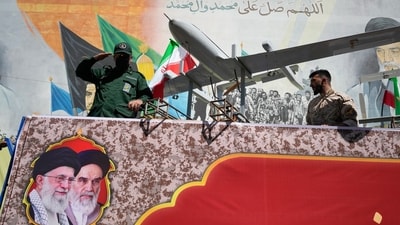 A member of Iran's Revolutionary Guard salutes while riding on a float displaying drones during the state-organized "Janfada," or "Sacrifice for Iran," military-style parade in Tehran. (AP) A member of Iran's Revolutionary Guard salutes while riding on a float displaying drones during the state-organized "Janfada," or "Sacrifice for Iran," military-style parade in Tehran. (AP)