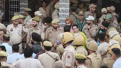 Policemen at the spot where villagers organised a protest in Sai Sardari village of the RS Pura sector in Jammu district.