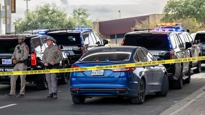 AUSTIN, TEXAS - SEPTEMBER 20: Law enforcement monitor a vehicle that was shot at by Immigration and Customs Enforcement officers on September 20, 2026 in Austin, Texas. A federal ICE officer shot and wounded a person earlier this afternoon in North Austin.   Brandon Bell/Getty Images/AFP (Photo by Brandon Bell / GETTY IMAGES NORTH AMERICA / Getty Images via AFP) (Getty Images via AFP)