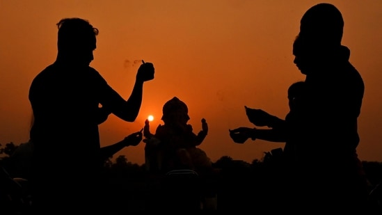 Gram it: Devotees offer prayers to Lord Ganesha before immersing an idol in the Yamuna river, on Sunday. The ongoing Ganeshotsav celebrations have taken over the city with much fervour.