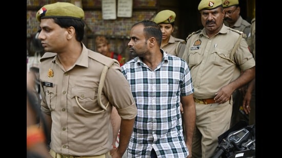 Police escorting Prashant Chaudhary, after the verdict in the Vivek Tiwari murder case. (Deepak Gupta/HT Photo)