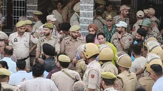 Policemen at the spot where villagers organised a protest in Sai Sardari village of the RS Pura sector in Jammu district.