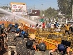 Haryana Police personnel using water cannons and tear gas as protesting farmers blocked the Delhi-Chandigarh highway at Shahbad in Kurukshetra district on Tuesday afternoon. (HT Photo)