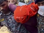 Jamui: Security personnel carry an accused allegedly involved in the harassment of a boy and a girl by the roadside, after he was shot in leg during a police encounter, in Jamui on Tuesday. (PTI)