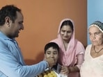 Shooter Himanshu Dhillon’s uncle, aunt and grandmother celebrating his victory, at Dahola village in Jind on Monday. (HT)