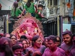 Devotees immerse an idol of Lord Ganesh in the water pond created by the Delhi government on the Ganesh Chaturthi festival in Delhi