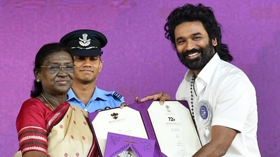 President Droupadi Murmu honours Actor Dhanush with a Special Mention (Actor) for the film 'Captain Miller' at the 72nd National Film Awards ceremony, in Kevadia on Tuesday. (@PIBAhmedabad X/ANI Photo) (   @PIBAhmedabad)