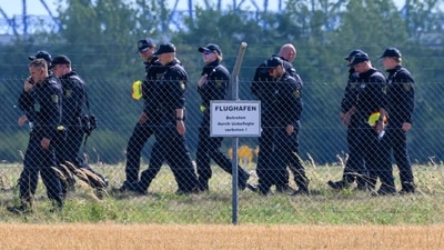 FILE PHOTO: A police officer in protective clothing works at Leipzig/Halle Airport in Schkeuditz, Germany, August 5, 2026, after the police said explosives experts examined a drone near a runway, and after a DHL cargo aircraft hit an unknown object as it was climbing away from the airport overnight, prompting an unscheduled landing in Hanover, according to a source familiar with the incident. FILE PHOTO: A police officer in protective clothing works at Leipzig/Halle Airport in Schkeuditz, Germany, August 5, 2026, after the police said explosives experts examined a drone near a runway, and after a DHL cargo aircraft hit an unknown object as it was climbing away from the airport overnight, prompting an unscheduled landing in Hanover, according to a source familiar with the incident.
