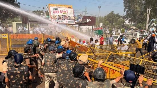 Haryana Police personnel using water cannons and tear gas as protesting farmers blocked the Delhi-Chandigarh highway at Shahbad in Kurukshetra district on Tuesday afternoon. (HT Photo)