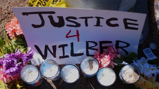 Flowers and candles are seen near the site where a Venezuelan man was shot in his vehicle by an ICE officer in Austin, Texas, Monday, Sept. 21, 2026. (AP Photo/Eric Gay)(AP Photo/Eric Gay)