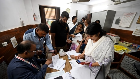 Voters arrive at a voter center to seek clarification and make correction to their SIR Forms at Laxmi Devi School Sadar Bazar, in New Delhi.