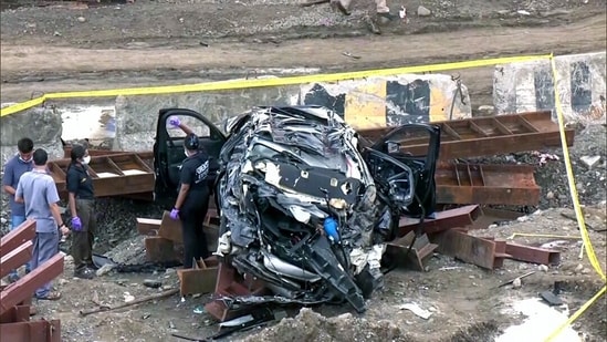 Forensic team work at the site following a fatal accident involving an overspeeding BMW on the Mumbai Coastal Road bridge near Lotus Jetty, resulting in the deaths of three people. (ANI)