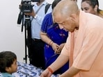 Chief minister Yogi Adityanath meets a child during the inauguration of a state women’s shelter, in Gorakhpur. ((@myogiadityanath/X via PTI Photo)) Chief minister Yogi Adityanath meets a child during the inauguration of a state women’s shelter, in Gorakhpur. ((@myogiadityanath/X via PTI Photo))