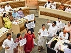 Councillors protesting against the BJP in the Well of the House during the meeting at municipal corporation office in Sector 17, Chandigarh on Tuesday. (Keshav Singh/HT)