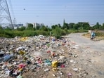 Illegally dumped garbage along the Sector-70A road near Pyramid Urban Homes housing society, as seen on Tuesday. (Parveen Kumar/Hindustan Times)